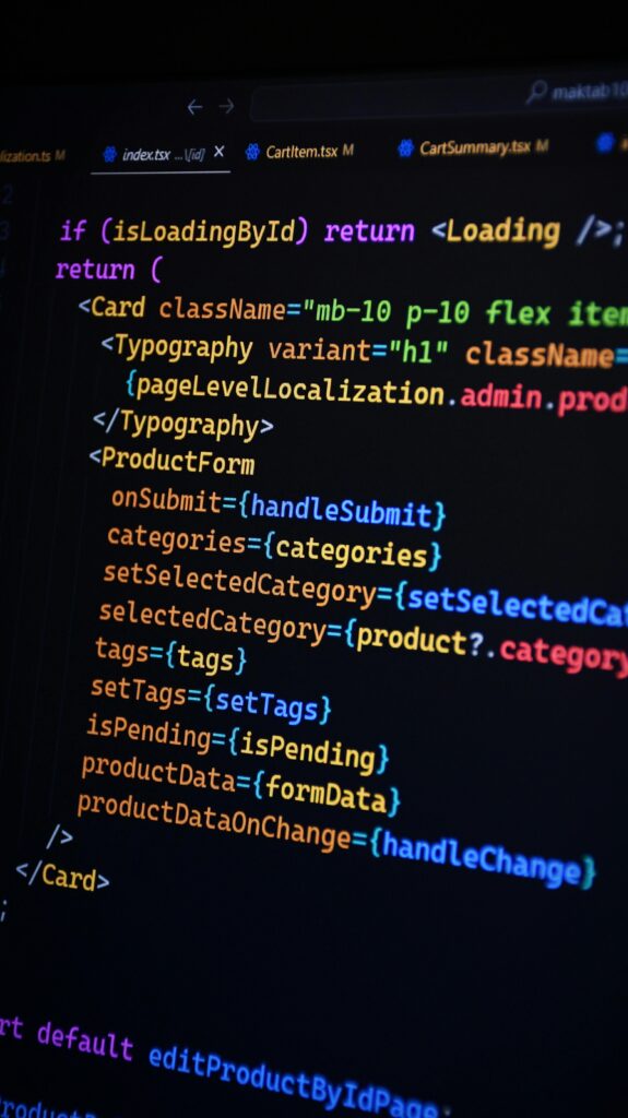 Close-up of JSX code on a monitor, showcasing colorful syntax used in ReactJS development.